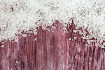 White sea salt on  red wood. Spa background. Spa concept.  Sea salt for bath. Sea salt for cosmetic...