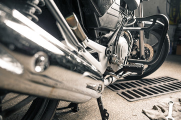 Close up of man's hands with motorcycle in garage