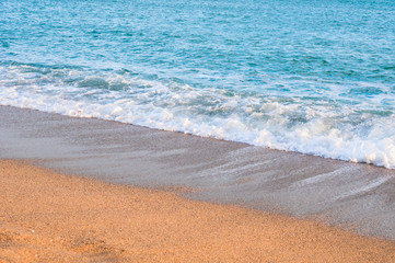 Sea wave on sandy beach