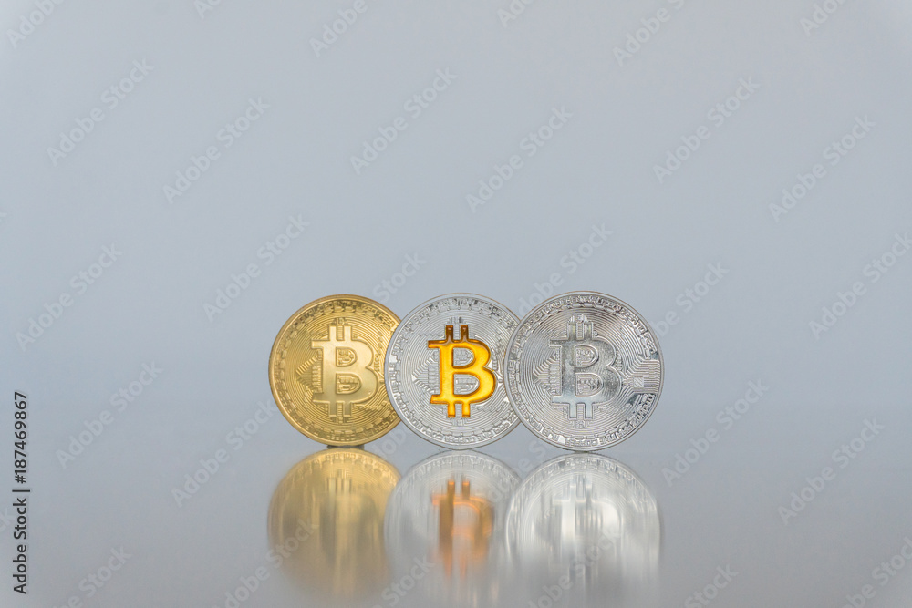 Wall mural A set of bitcoins. Platinum, silver and gold coins isolated on a light background