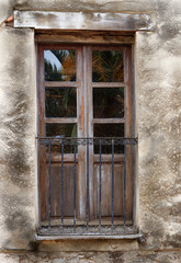 Old door of a balcony with iron railing