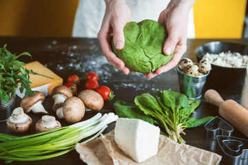 Chef cook step by step makes green ravioli in the shape of a heart for a festive dinner