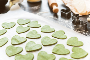 Obraz na płótnie Canvas Chef cook step by step makes green ravioli in the shape of a heart for a festive dinner
