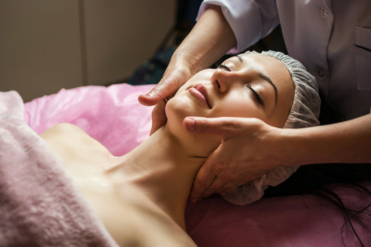 calm girl having spa facial massage in luxurious beauty salon