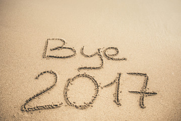 Bye 2017 text written on the sand