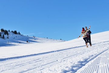 Couple having fun running down slope