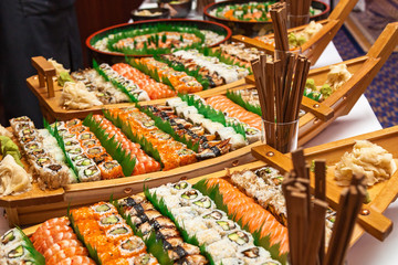Sushi boat with chopsticks on white table.Sushi boat