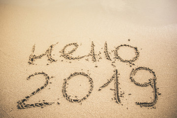 Hello 2019 text written on the sand