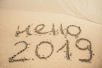 Hello 2019 text written on the sand