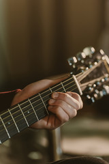 cropped shot of man playing acoustic guitar