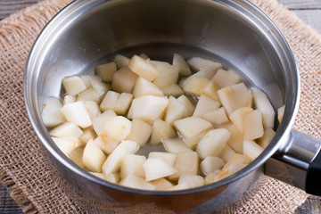 Pieces of pear in a saucepan. Preparing children's puree