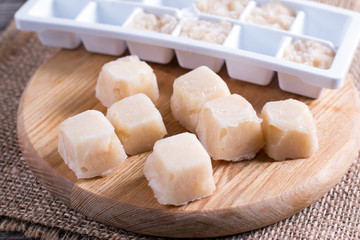 Frozen pear puree on a cutting board on a table