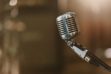 Fototapeta na wymiar Close-up shot of vintage microphone on blurred background