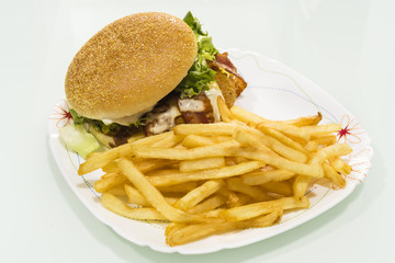 Hamburger with potatoes on a plate made at home