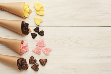 Lovers day background with various sweets in craft cornets