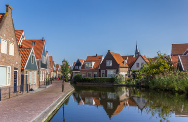 Fototapeta na wymiar Street with small houses at the canal of Volendam