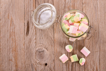 Marshmallows on wooden table.