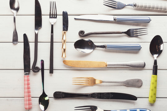 Collection of modern and antique cutlery, top view