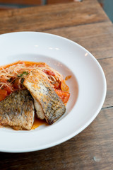 Grilled sea bass and spaghetti with tomato sauce