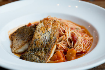 Grilled sea bass and spaghetti with tomato sauce