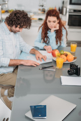 couple of travelers planning trip and looking at map