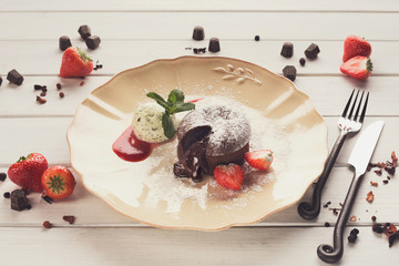 Chocolate fondant with vanilla ice cream and strawberry