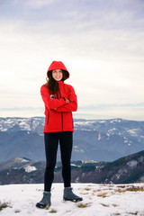 Female hiker on snow covered mountain top