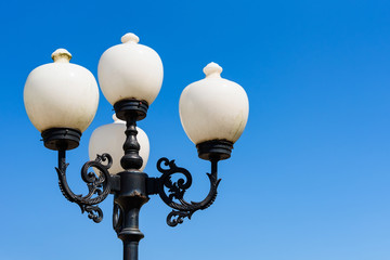 Street lights against a blue sky day. Space for text.