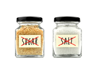 Concept of no salt and no sugar in a glass jar with black lid and yellow sticky notes isolated on white background, front view.