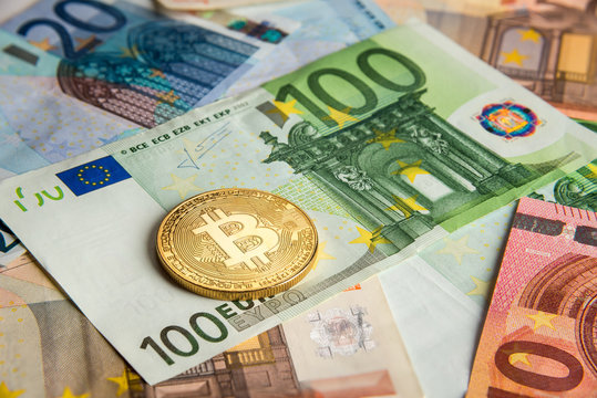 Bitcoin gold coin on euro banknotes