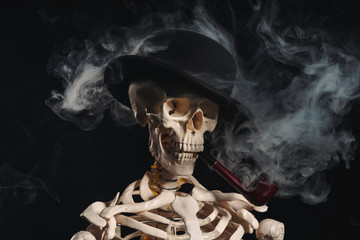 Skeleton in bowler hat smoking pipe