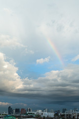 Rainbow above the cloudy sky with bangkok city view