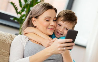 happy family with smartphone at home