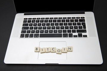 Bitcoin text on a modern laptop. 