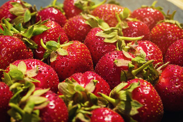 strawberries on stone background, delicious first class organic fruit as a concept of summer vitamins