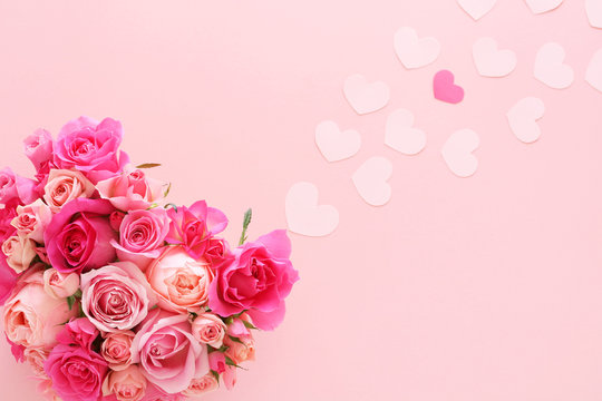 Valentines background with heart shaped bouquet and paper hearts