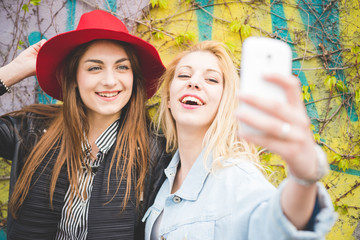 Youn beautiful blonde and brunette girl taking selfie