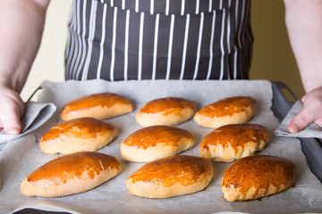 Traditional Russian baked pies (pirozhki). Close-up, selective focus.