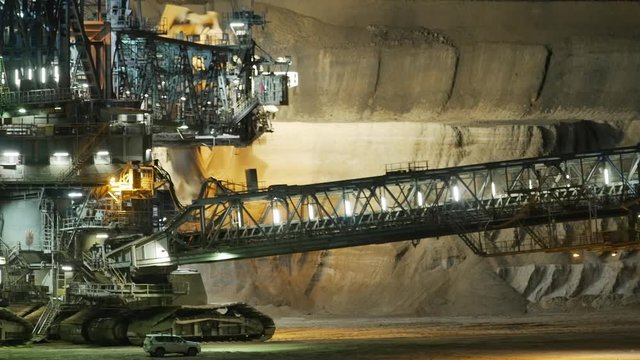 coal digger opencast pit at night timelapse zoom lens