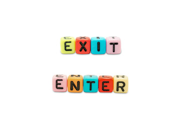 Close up image of the alphabet dices which are arranged for the word EXIT and ENTER, isolated on white background and embedded clipping path.