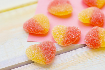Gummy hearts on pink paper
