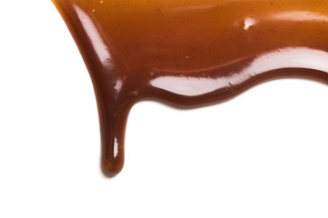 Chocolate caramel sauce drop on a plain white backround