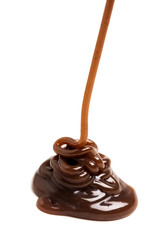 Chocolate caramel sauce pouring on a plain white backround