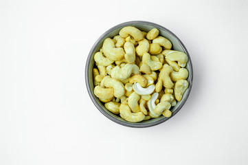 cashew nuts in a bowl, top view isolated