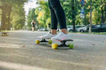Girl on a skateboard. Park background. © Michał Magiera