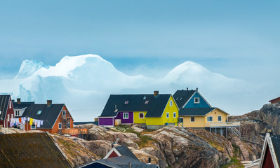 Huge icebergs stranded on the shores of the city of Iulissat, Greenland - obrazy, fototapety, plakaty