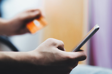 men hands, holding the phone and a visa card or other