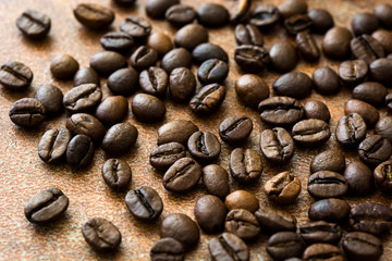 Roasted coffee beans on brown rustic background