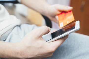 men hands, holding the phone and a visa card or other