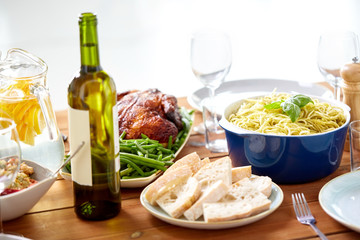 bottle of wine and food on served wooden table